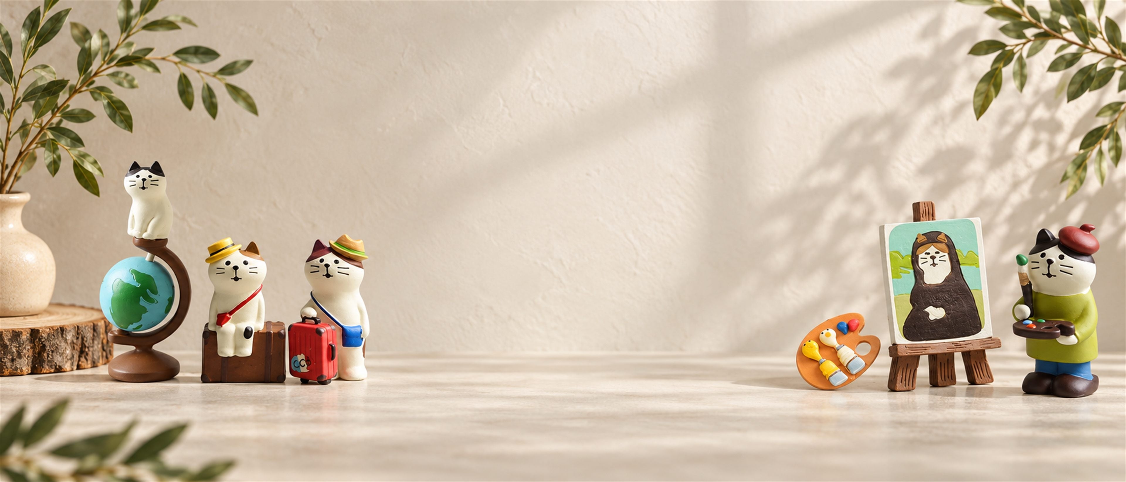 Travel and artist cat miniatures in a light natural setting